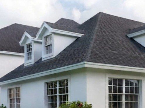 Conceptual image of a large white home with dormer windows near Albany