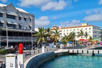 Downtown Nassau waterfront with palm trees and colorful shops